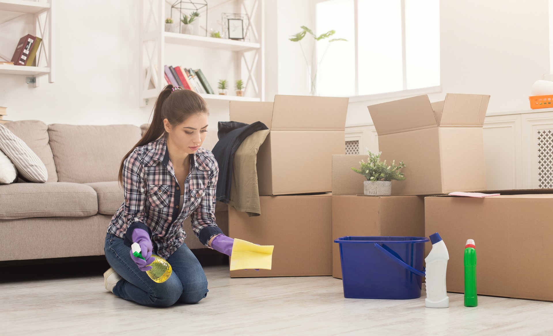 Young woman cleaning home with mop